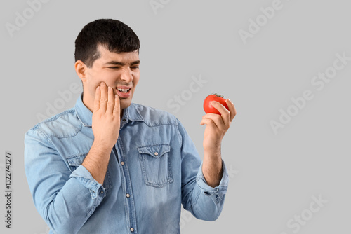 Young man with tomato suffe...