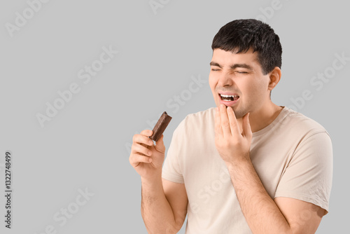 Young man with candy bar su...