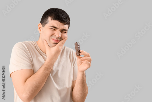 Young man with candy bar su...
