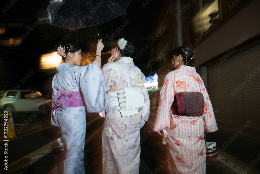 People having fun wearing kimono at night in Japan People having fun wearing kimono at night in Japan