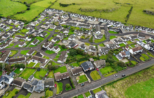 Aerial view of recent private housing development on west edge of coastal village of Portballintrae near Bushmills, Northern Ireland