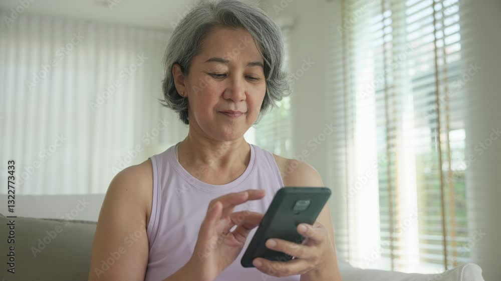Asia adult people middle age happy relax old woman using mobile ask AI chatGPT chat bot look health care app sit at home sofa elder aging asian aged female. Online social media smart pay order system. Asia adult people middle age happy relax old woman using mobile ask AI chatGPT chat bot look health care app sit at home sofa elder aging asian aged female. Online social media smart pay order system.