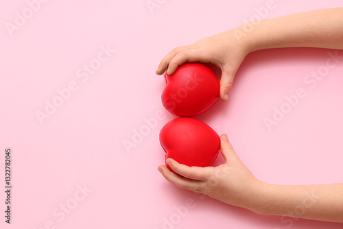 Child's hands with red hear...