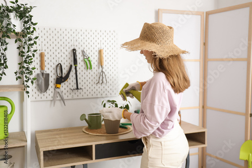 Female gardener spraying ho...