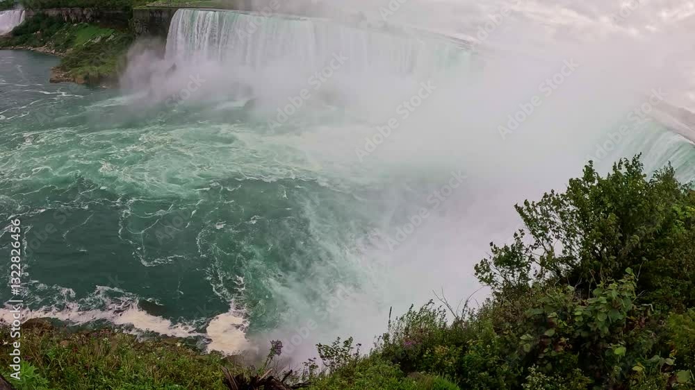 Stunning View of Niagara Falls, Canada breathtaking view of Niagara Falls in Canada, showcasing powerful cascading water, mist rising, and lush greenery along edge of the falls. Stunning View of Niagara Falls, Canada breathtaking view of Niagara Falls in Canada, showcasing powerful cascading water, mist rising, and lush greenery along edge of the falls.