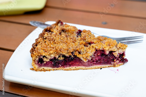 Slice of Homemade Berry Crumble Pie on White Plate
