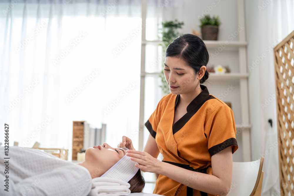 Asian young woman getting head and facial massage treatment at beauty spa. Asian young woman getting head and facial massage treatment at beauty spa.