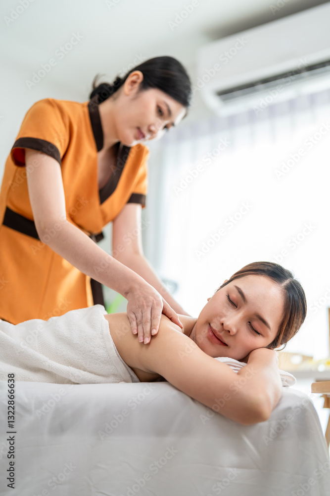 Asian young woman getting back massage treatment with oil at beauty spa. Asian young woman getting back massage treatment with oil at beauty spa.
