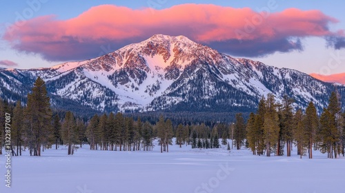 Majestic Snow-Covered Mountain with Pink Clouds Above at Dusk in a Winter Landscape