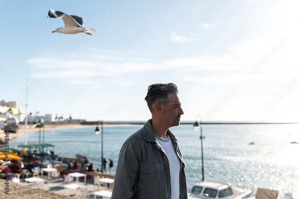 Traveler enjoying quality time by seaport Traveler enjoying quality time by seaport
