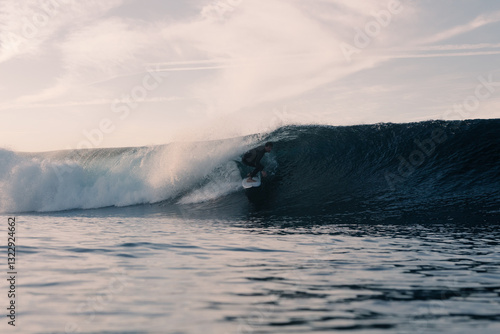 Talented surfer carving the heart of a wave executing a tube ride photo