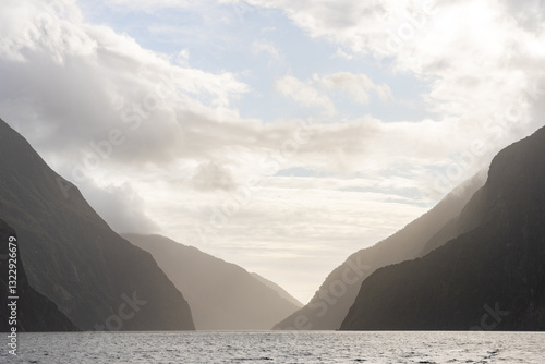 Evening light creating layers of mountains in the Milford Sound, NZ photo