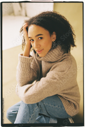 A young multiracial woman striking a pose in a studio photo