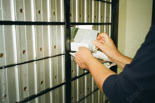 A man pulls mail out of a mailbox