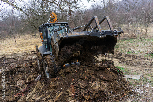 A backhoe loader moves earth
