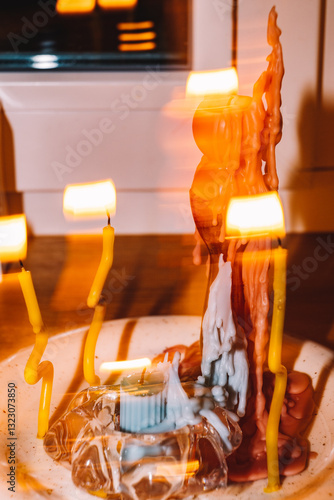 Colorful candles flicker around a unique sculptural centerpiece photo