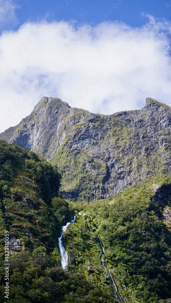 Milford Sound New Zealand waterfalls into the fjord Milford Sound New Zealand waterfalls into the fjord