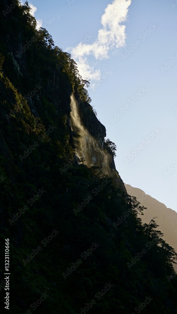 Milford Sound New Zealand waterfall during sunset Milford Sound New Zealand waterfall during sunset