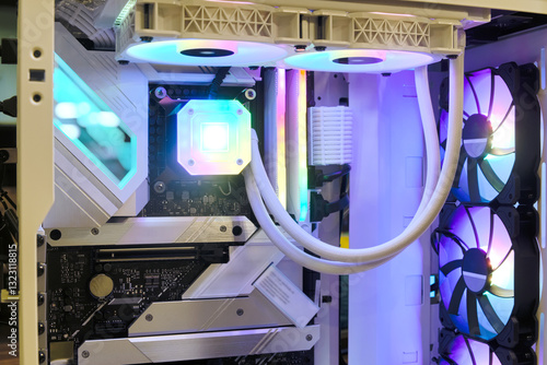 Close-up inside Hi-performance custom computer desktop with liquid pump that installed on socket CPU processor,  radiator and cooling fan for cooling and LED neon light show status on working