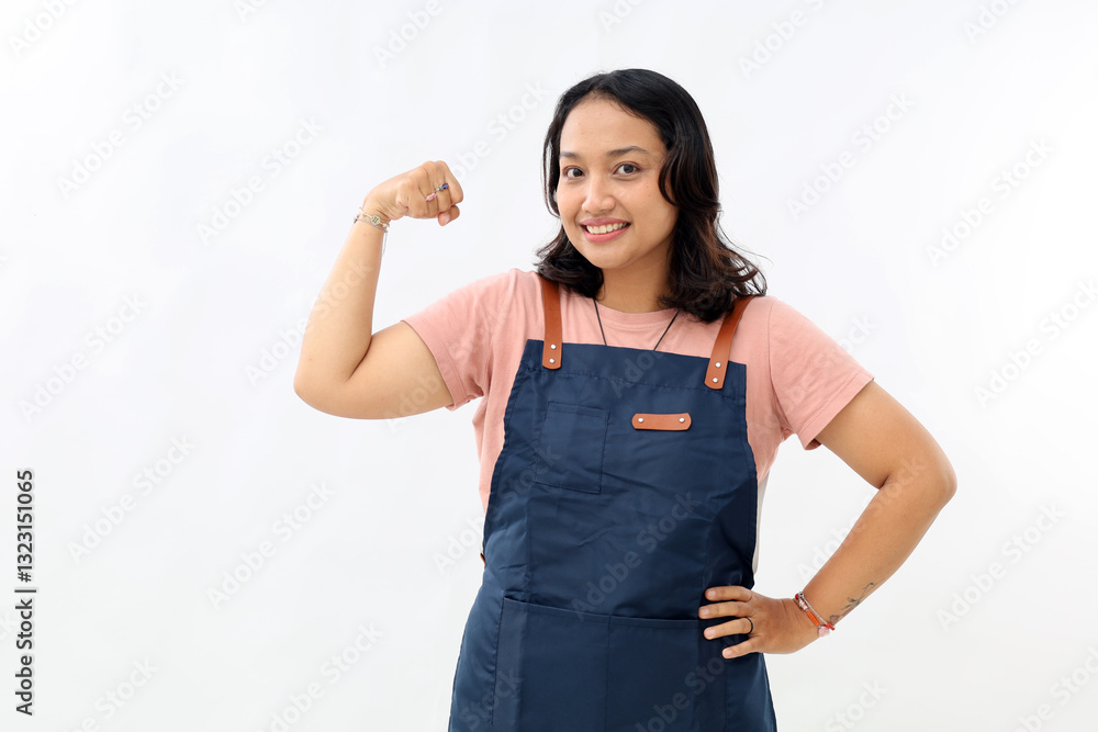 Asian young woman wearing apron over white background strong person showing arm muscle, confident and proud of power Asian young woman wearing apron over white background strong person showing arm muscle, confident and proud of power