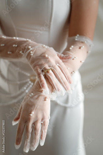 Beautiful bride in white wedding dress and gloves, close-up