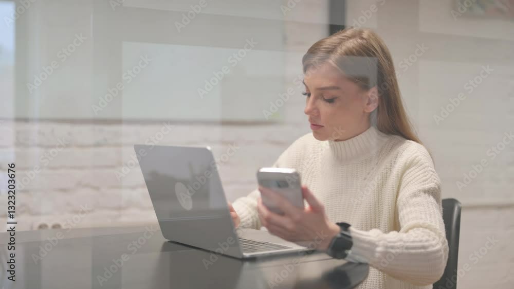 Female Employee Using Phone with Laptop Female Employee Using Phone with Laptop