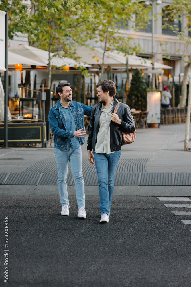 Gay couple enjoying a walk on a vibrant street in Madrid Gay couple enjoying a walk on a vibrant street in Madrid