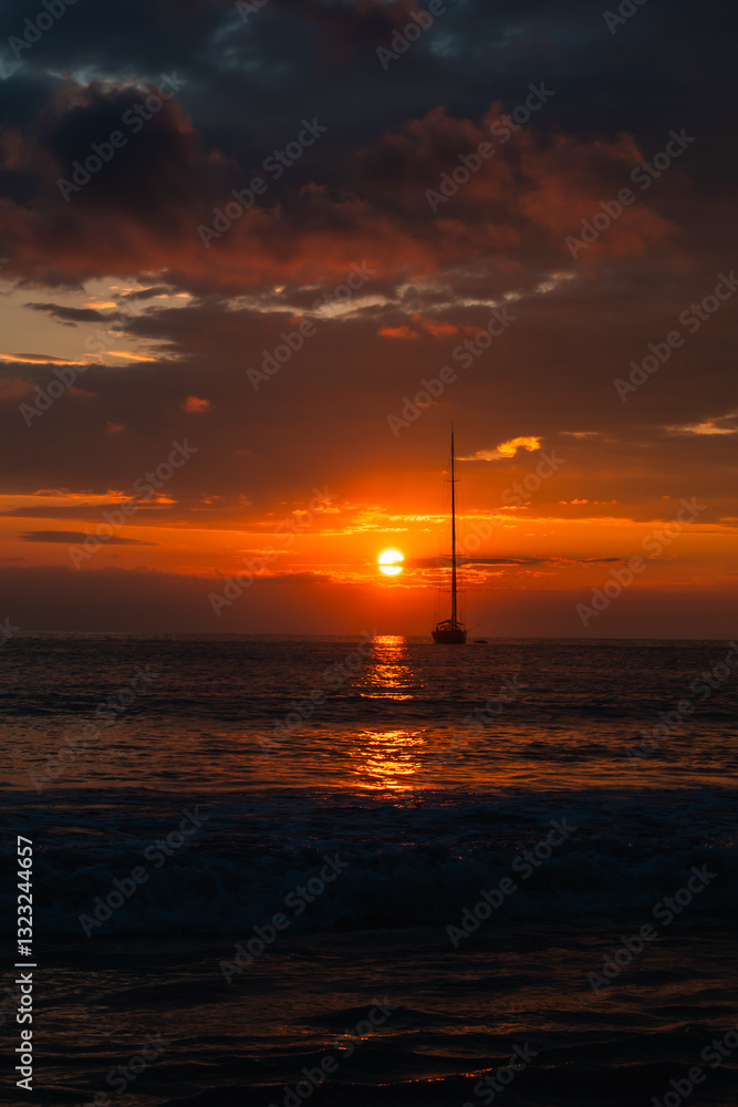 Beautiful sunset over ocean with sailboat on horizon shot from beach. Beautiful sunset over ocean with sailboat on horizon shot from beach.