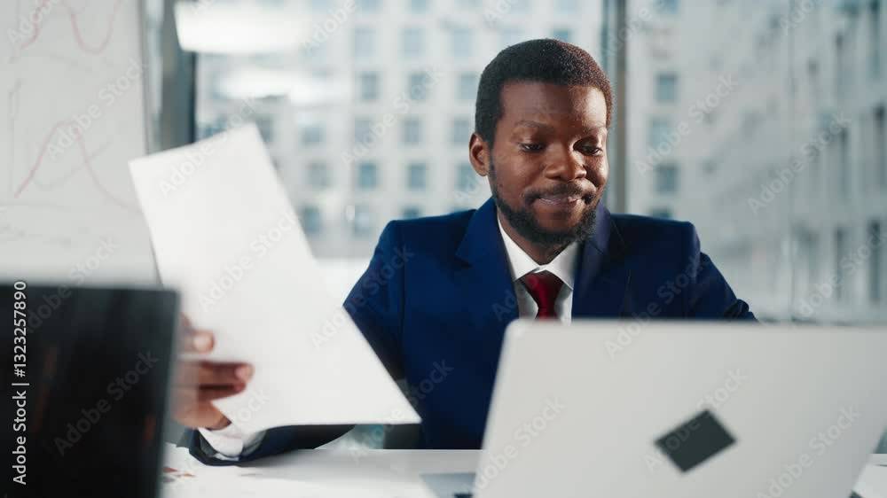 Successful African American businessman in office, man viewing financial reports . Financial analyst working with computer in office or co-working, marketing professional planning strategy of company Successful African American businessman in office, man viewing financial reports . Financial analyst working with computer in office or co-working, marketing professional planning strategy of company