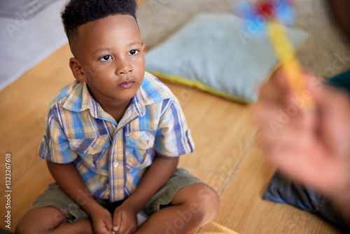 Young boy watching parent's hand