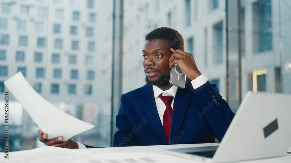 World economic crisis, head of big company talking by phone with partners. Nervous and angry African American man swaying papers emotionally, portrait in office, manager or financial professional World economic crisis, head of big company talking by phone with partners. Nervous and angry African American man swaying papers emotionally, portrait in office, manager or financial professional