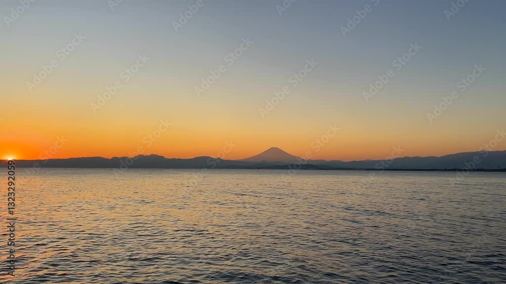 Stunning sunset from Enoshima with Mt. Fuji silhouette in distance Stunning sunset from Enoshima with Mt. Fuji silhouette in distance