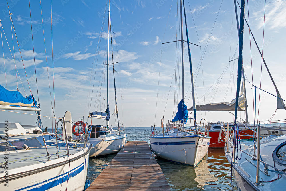 Fototapeta premium Line of Colorful Sailing Boats at Fishermans Pier.