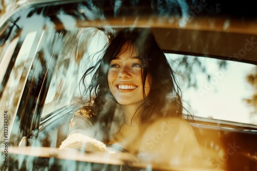 Obraz na płótnie Smiling woman driving a car, captured through the windshield with warm sunlight w salonie
