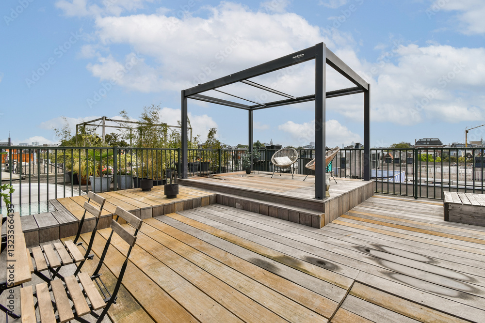 Fototapeta premium An expansive rooftop area featuring comfortable seating and panoramic views of the surrounding cityscape and greenery, ideal for relaxation or gatherings.