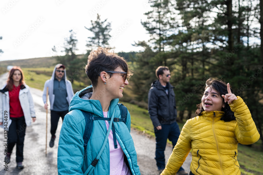 Hikers walking and chatting along a mountain road in Spain Hikers walking and chatting along a mountain road in Spain