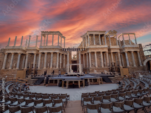 People setting up and preparing the stage in the Roman Amphitheater in Merida during sunset.