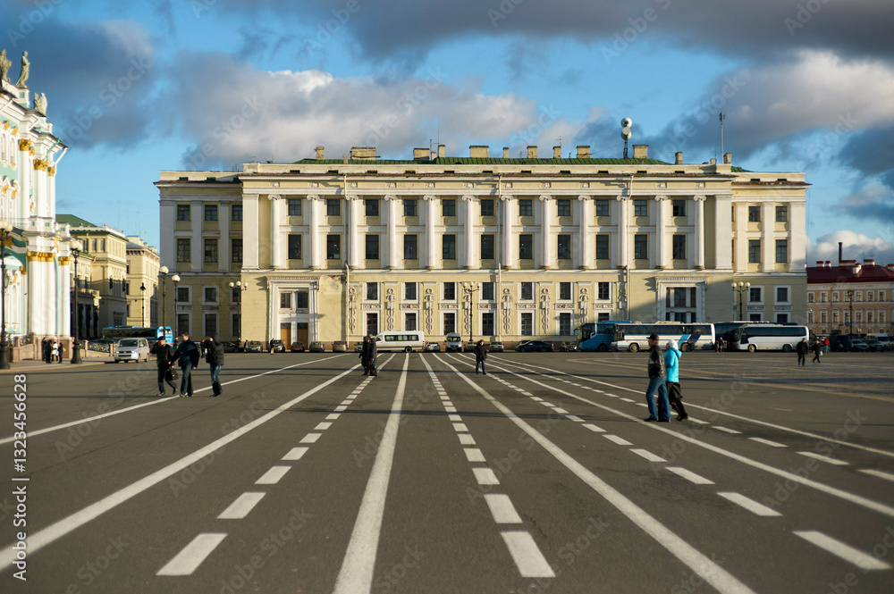 Wide open city square with people walking on lined pavement and historic building. St. Petersburg, Russia Wide open city square with people walking on lined pavement and historic building. St. Petersburg, Russia