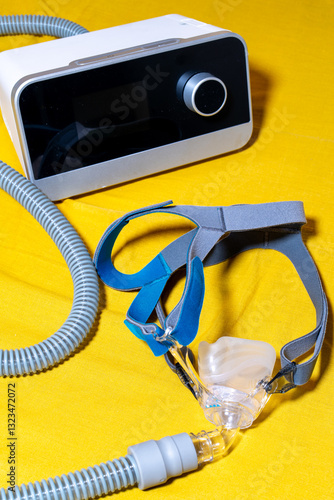 Obstructive Sleep Apnea cpap machine on a yellow surface.