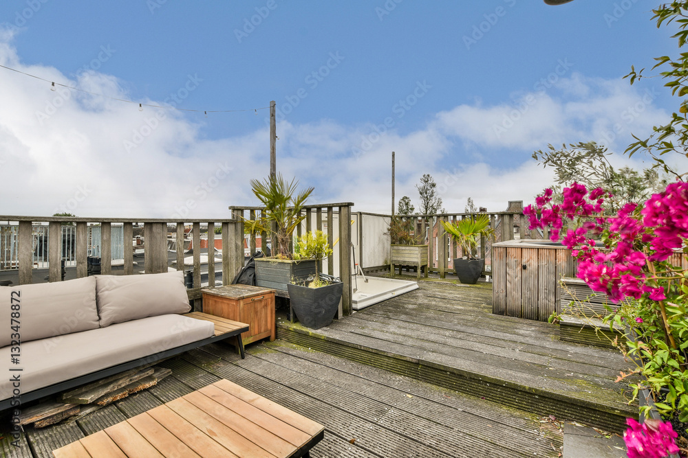 A serene rooftop space featuring comfortable seating, decorative plants, and a natural wood deck, ideal for relaxation and socializing. A serene rooftop space featuring comfortable seating, decorative plants, and a natural wood deck, ideal for relaxation and socializing.