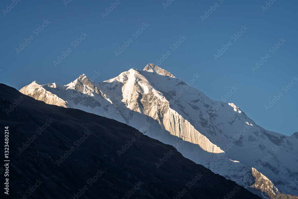 Scenic mountain landscape view of majestic snowcapped Rakaposhi peak in Karakoram range in early morning, Karimabad, Hunza, Gilgit-Baltistan, Pakistan Scenic mountain landscape view of majestic snowcapped Rakaposhi peak in Karakoram range in early morning, Karimabad, Hunza, Gilgit-Baltistan, Pakistan