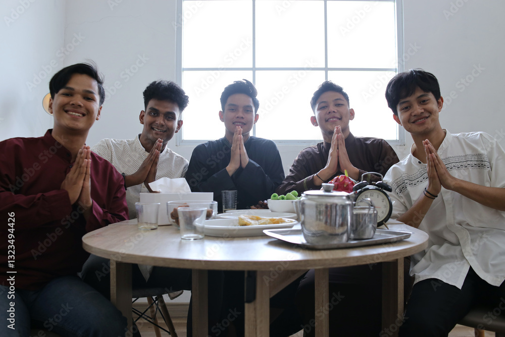 Group of Muslim Men Showing Greeting Hand Gesture in The Dining Table During Ramadan Celebration Group of Muslim Men Showing Greeting Hand Gesture in The Dining Table During Ramadan Celebration