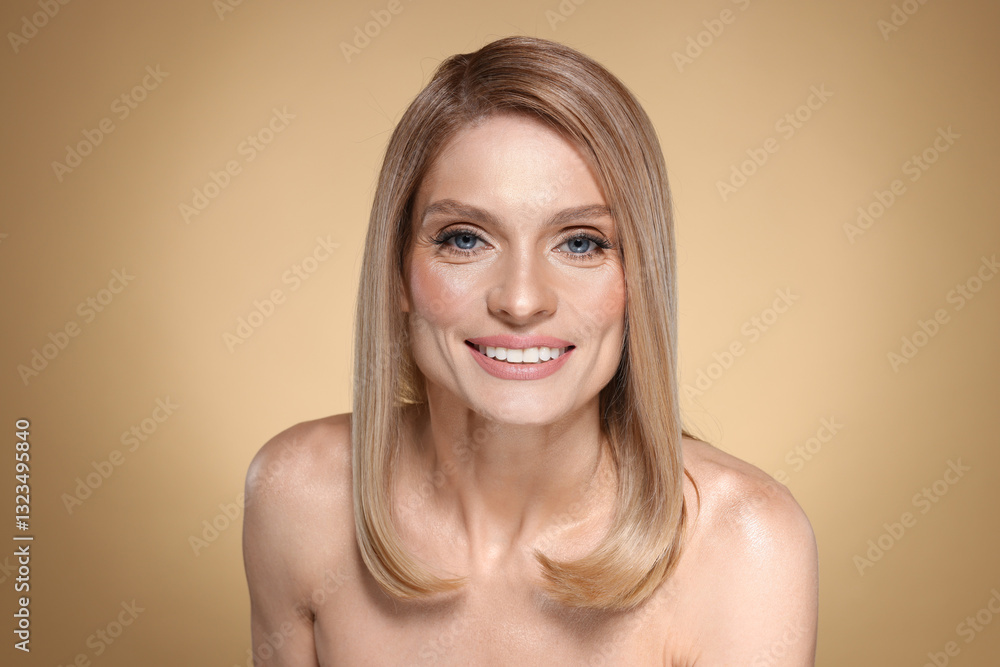 Portrait of beautiful happy woman with straight blonde hair on beige background Portrait of beautiful happy woman with straight blonde hair on beige background