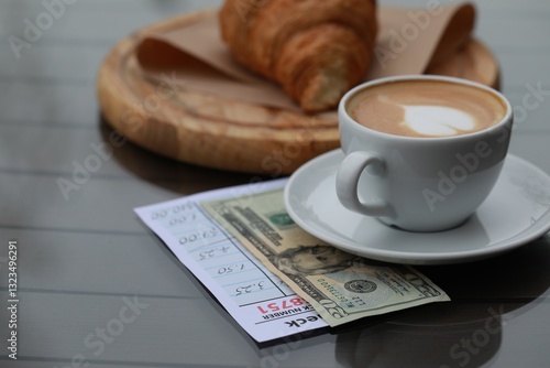 Tableau sur toile Croissant, coffee, tip and receipt on wooden table