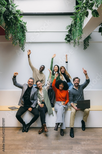 Diverse team celebrating success in modern workspace