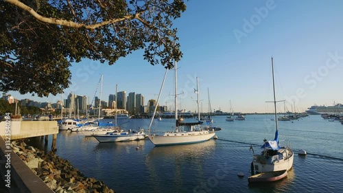 Marina with boats and city skyline in the background on a clear day in San Diego, California in 4k