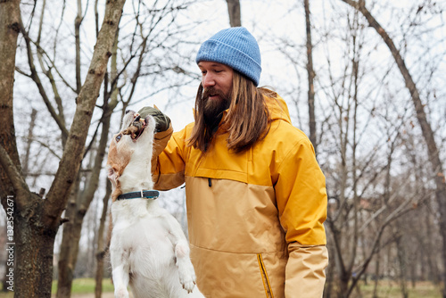 Man entertains his dog in nature photo