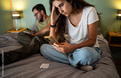 Woman Focused on Birth Control Pills While Partner is distracted photo