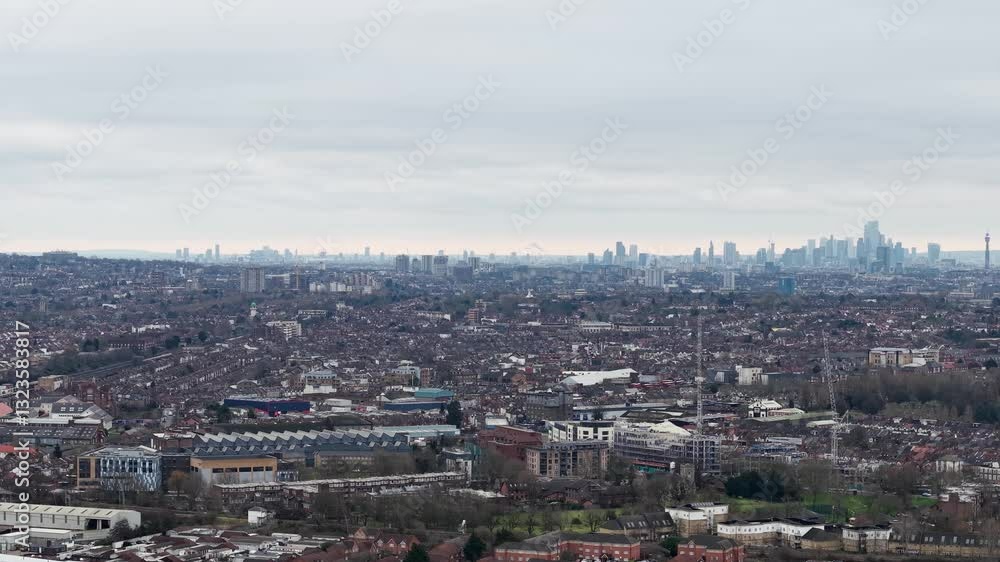 Aerial View Of Wembley With City Skyline In Fog In Distance. London Borough Of Brent, England. sideways shot Aerial View Of Wembley With City Skyline In Fog In Distance. London Borough Of Brent, England. sideways shot