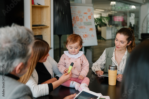 Baby joy during a friendly work meeting in modern office photo